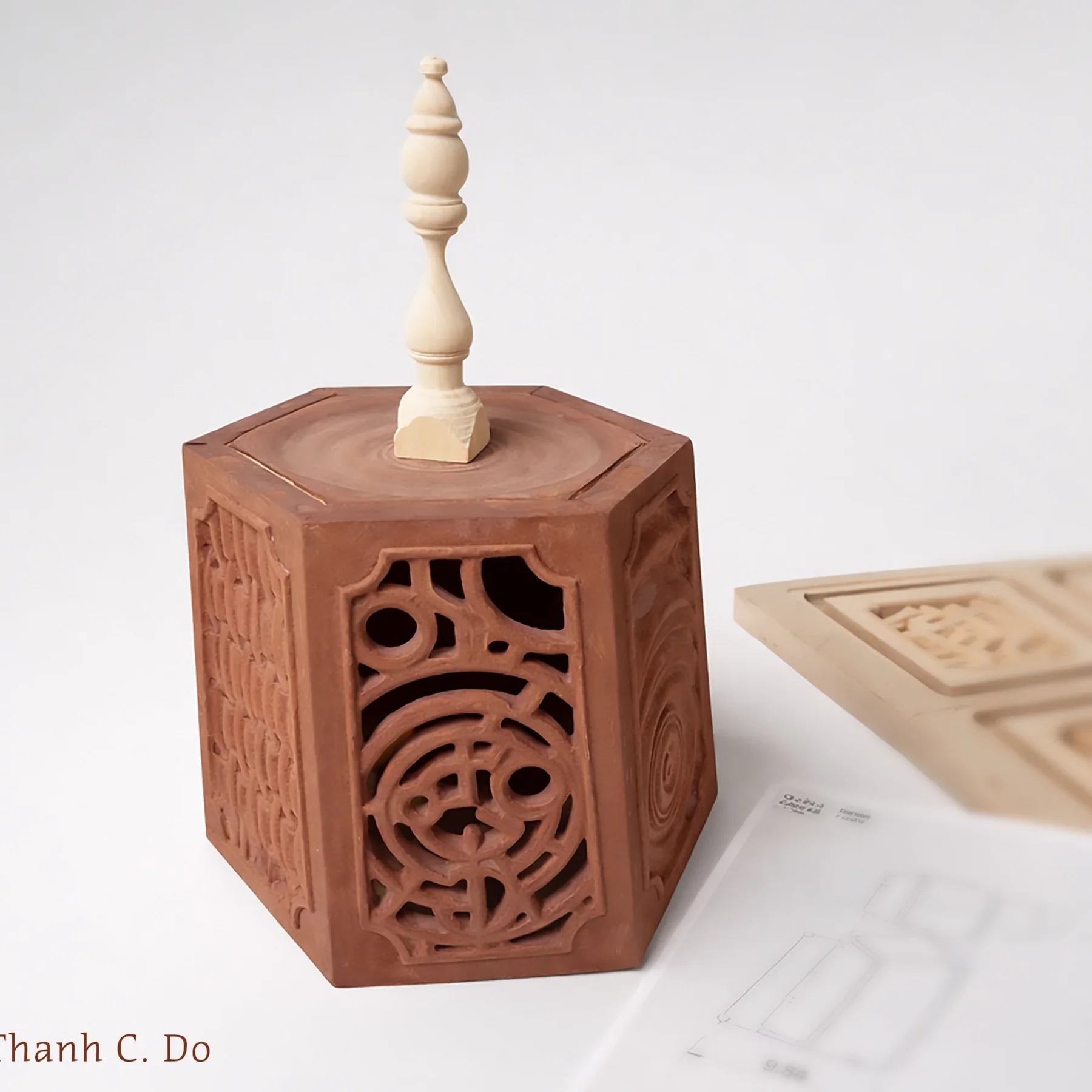 Geometric carved wooden vessel with delicate openings